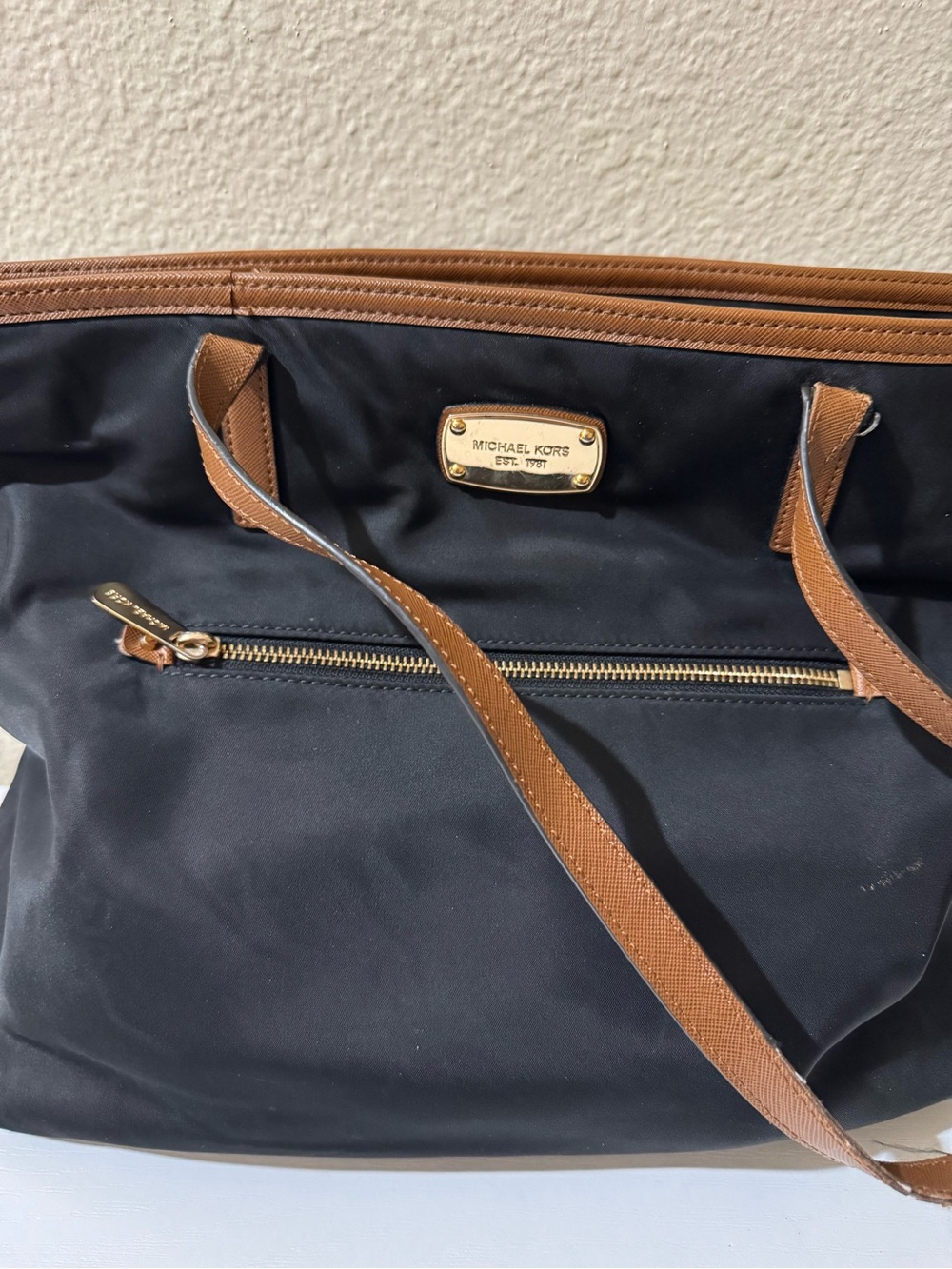 Michael Kors Black Tote with Brown Trim and Gold Plate